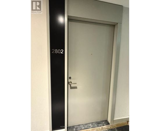 A door with a handle and a number 2802 on the wall.