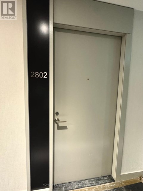 A door with a handle and a number 2802 on the wall.