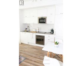 A white kitchen with a microwave above the stove.