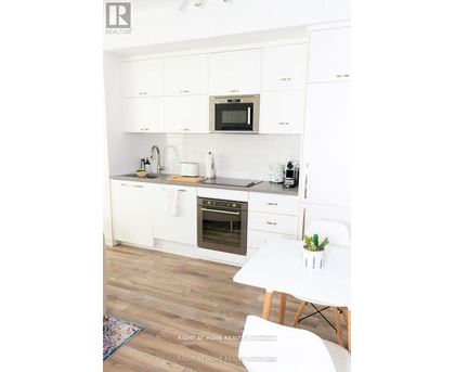 A white kitchen with a microwave above the stove.