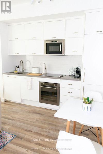 A white kitchen with a microwave above the stove.