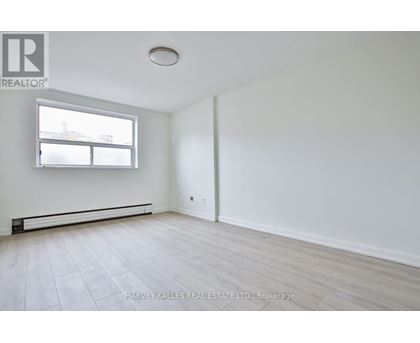 A spacious room with a window and a door.