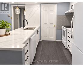 A kitchen with a sink and a white door.