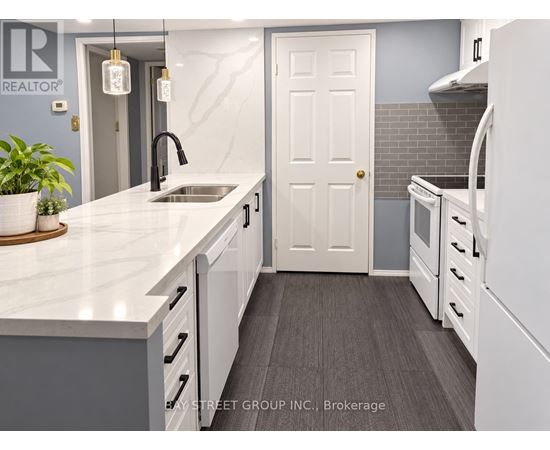 A kitchen with a sink and a white door.
