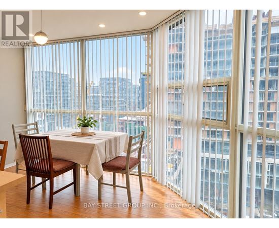 A dining room with a table set for two with a view of the city.