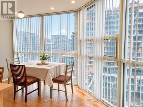 A dining room with a table set for two with a view of the city.