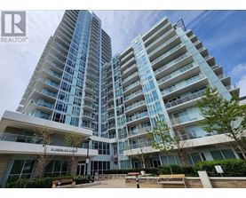 A modern apartment complex with a glass facade and a sign that reads "10 Deerlick Courts".