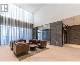 A living room with a stone wall and a glass door.