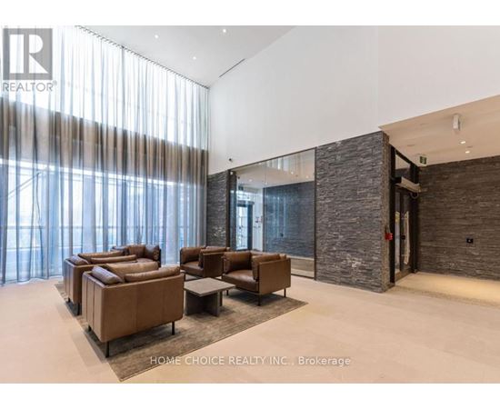 A living room with a stone wall and a glass door.