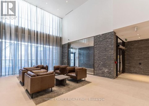 A living room with a stone wall and a glass door.