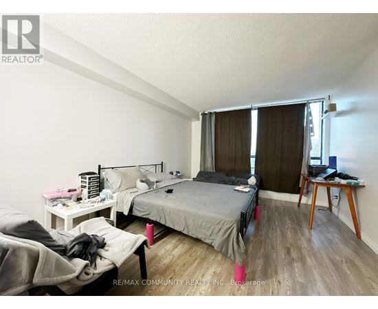 A bedroom with two beds and a desk.
