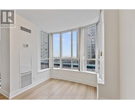 A room with a large window overlooking a cityscape.