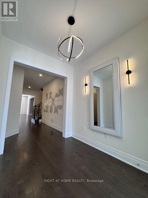 A hallway with a large mirror and lights on the wall.