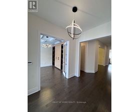 A large open room with a chandelier hanging from the ceiling.