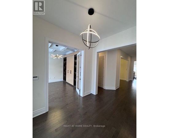 A large open room with a chandelier hanging from the ceiling.