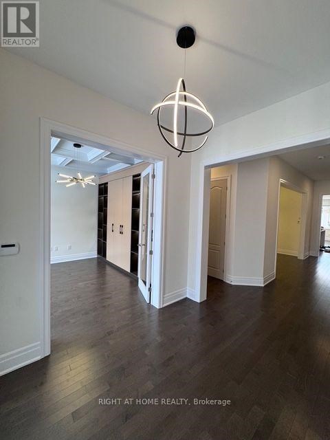 A large open room with a chandelier hanging from the ceiling.