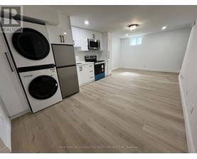 A laundry room with a washer and dryer stacked on top of each other.