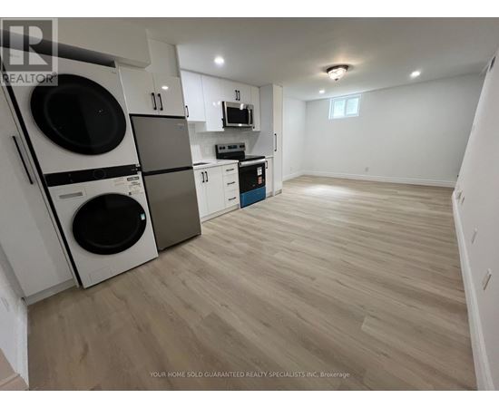 A laundry room with a washer and dryer stacked on top of each other.
