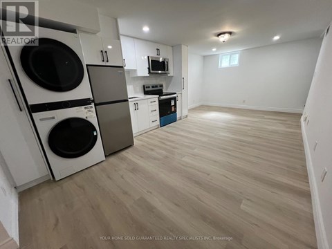 A laundry room with a washer and dryer stacked on top of each other.