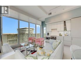 A modern living room with a view of the cityscape outside the large windows.