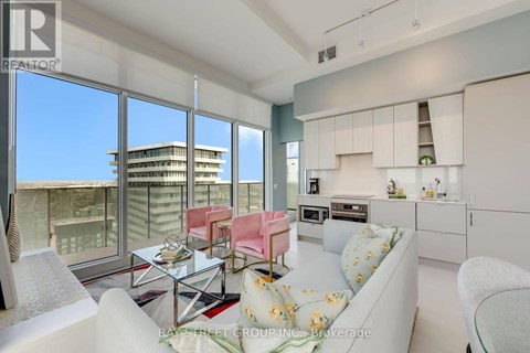 A modern living room with a view of the cityscape outside the large windows.