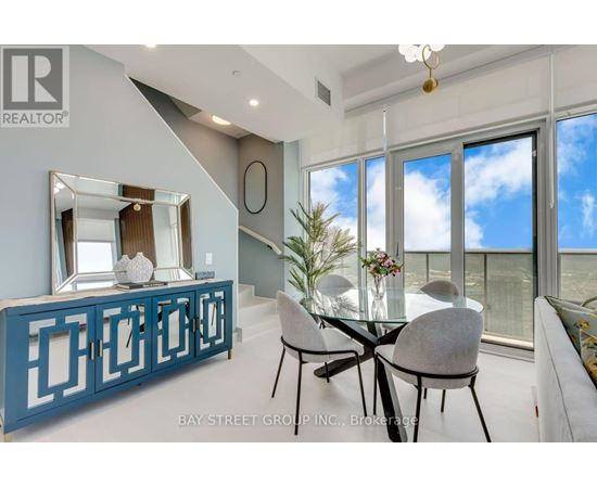 A dining room with a glass table and chairs.