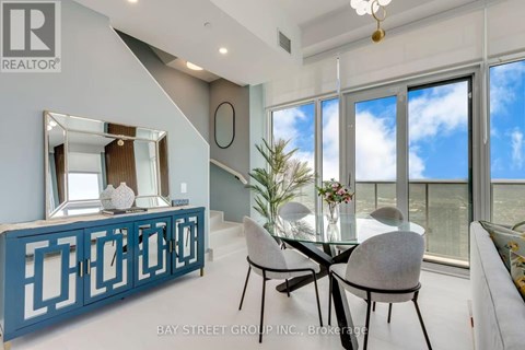 A dining room with a glass table and chairs.