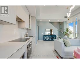 A modern kitchen with white cabinets and a large island.