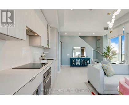 A modern kitchen with white cabinets and a large island.