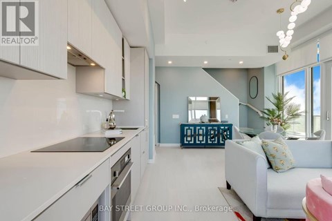 A modern kitchen with white cabinets and a large island.