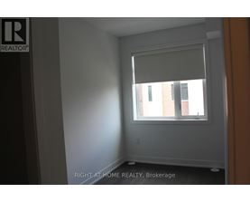 A room with a window and a wall with a logo that says REALTOR.
