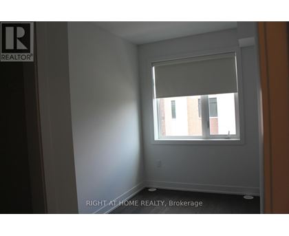A room with a window and a wall with a logo that says REALTOR.
