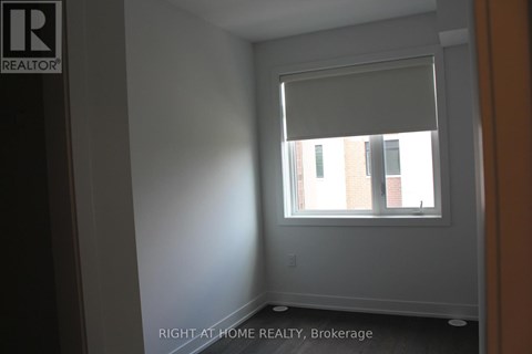 A room with a window and a wall with a logo that says REALTOR.