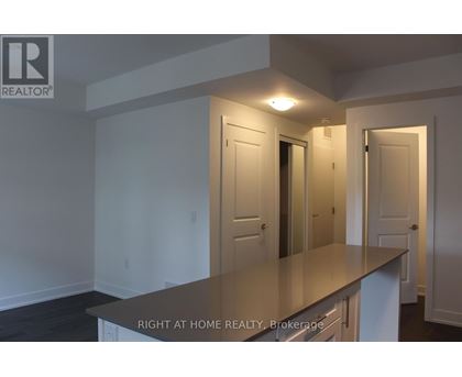 A room with a counter top and a door in the background.