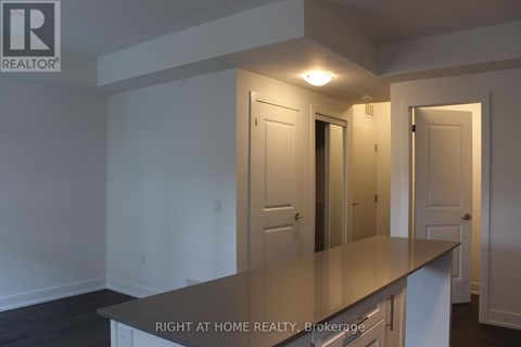 A room with a counter top and a door in the background.