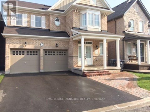 A large, two-story house with a brick facade and a large front yard.