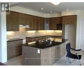 A kitchen with wooden cabinets and a black countertop.