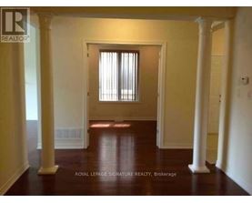 A room with a doorway and pillars.