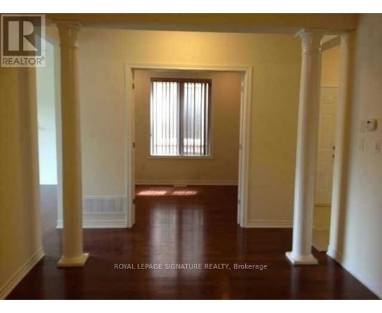 A room with a doorway and pillars.