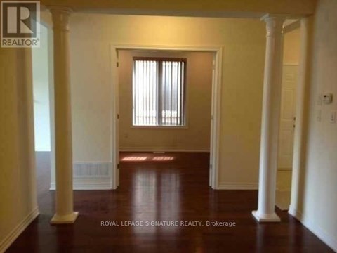 A room with a doorway and pillars.