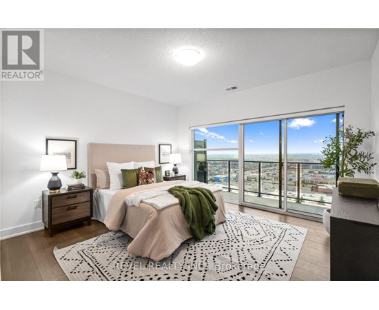 A bedroom with a large bed and a view of the city.