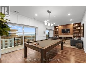 A well-lit room with a pool table and a view of the city.