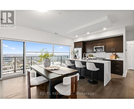 A modern kitchen with a dining table and chairs.