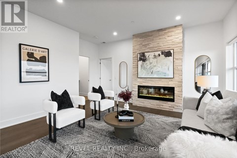 A living room with a fireplace and a painting on the wall.