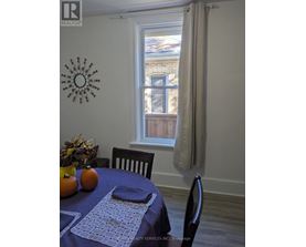 A dining room with a table set for two.