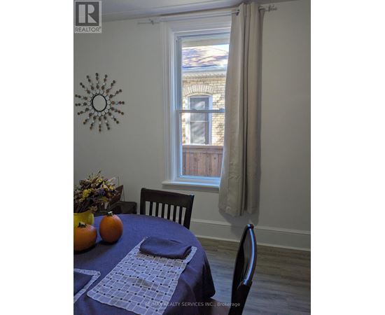 A dining room with a table set for two.