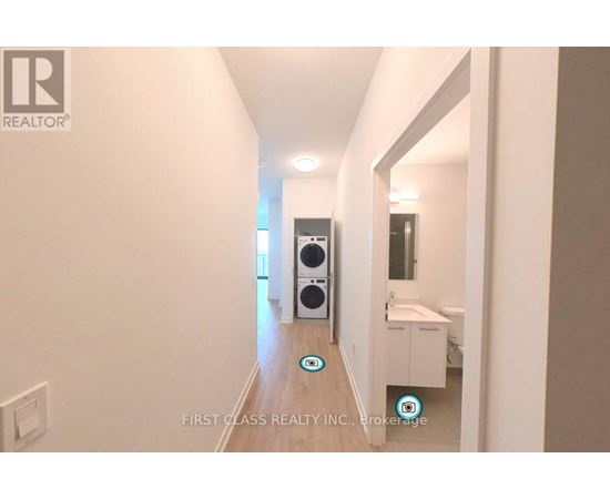 A hallway with a washing machine and dryer in it.
