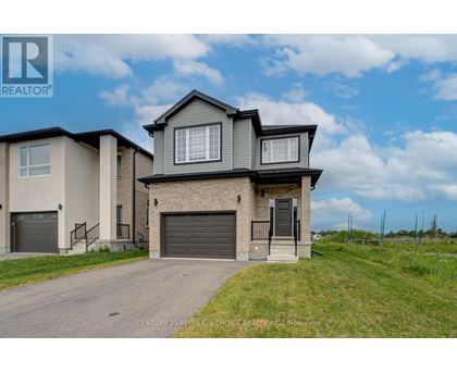 A house with a grey garage door is for sale.