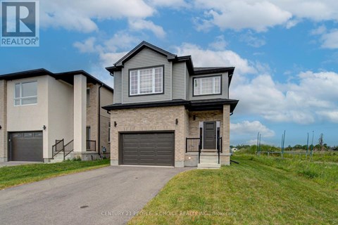 A house with a grey garage door is for sale.