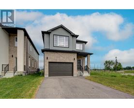 A house with a grey garage door is for sale.